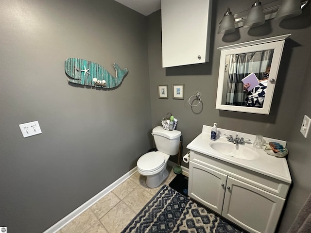 bathroom featuring toilet, tile patterned flooring, and vanity