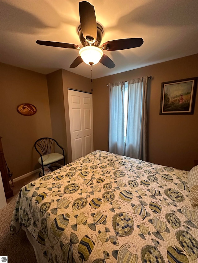 carpeted bedroom with a closet and ceiling fan