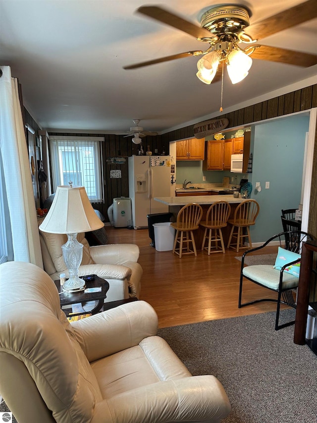 living room featuring sink, ceiling fan, and hardwood / wood-style floors