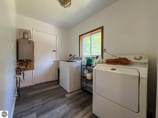 laundry room with laundry area, washing machine and dryer, water heater, and dark wood finished floors