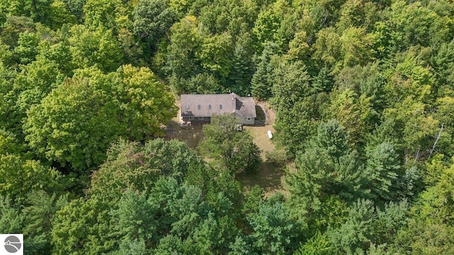 birds eye view of property with a view of trees