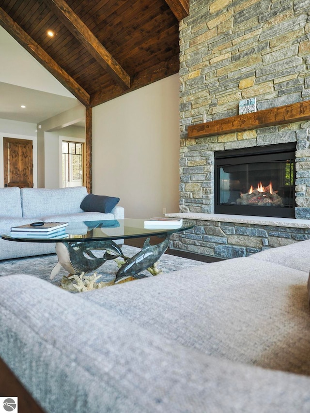 living room with beamed ceiling, high vaulted ceiling, wood ceiling, and a fireplace