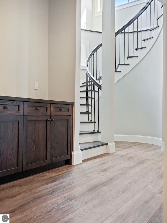 11305 Evergreen, Charlevoix, MI 49720 - staircase featuring wood finished floors, baseboards, and a high ceiling