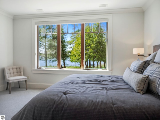 carpeted bedroom featuring ornamental molding