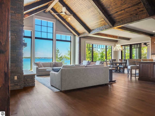 living room with beam ceiling, high vaulted ceiling, dark wood-type flooring, and a water view