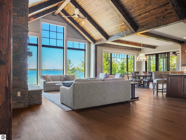 11305 Evergreen, Charlevoix, MI 49720 - living room with a chandelier, dark wood finished floors, high vaulted ceiling, a water view, and wood ceiling with exposed beams