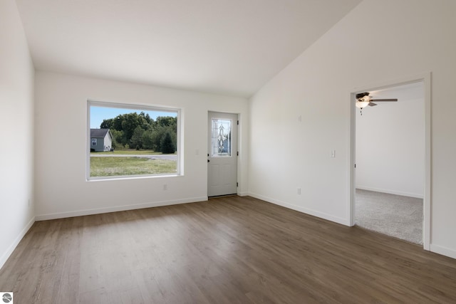 spare room with ceiling fan, high vaulted ceiling, and carpet