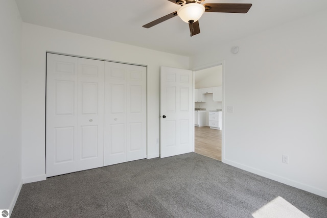 unfurnished bedroom featuring ceiling fan, a closet, and carpet floors