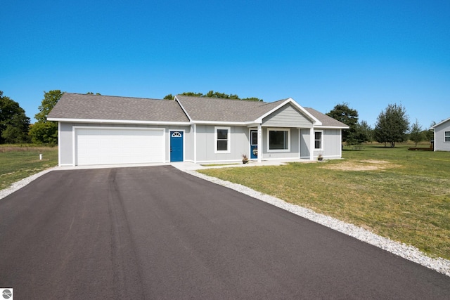 single story home featuring aphalt driveway, roof with shingles, an attached garage, board and batten siding, and a front yard