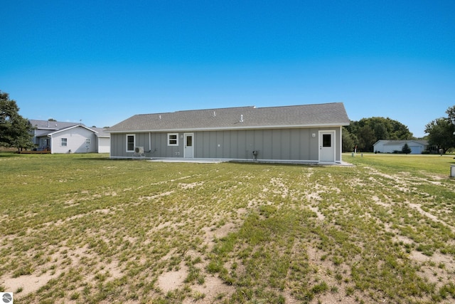 rear view of property with a lawn