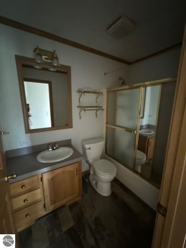 full bathroom featuring shower / bath combination with glass door, crown molding, toilet, and vanity