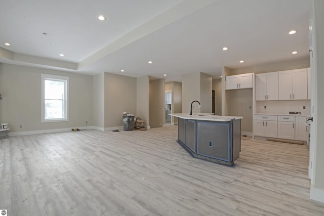 kitchen featuring recessed lighting, open floor plan, and light wood-style flooring