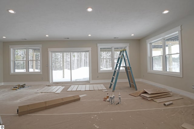 interior space featuring a healthy amount of sunlight, baseboards, and recessed lighting