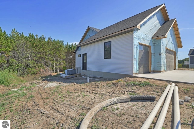 rear view of property featuring a garage