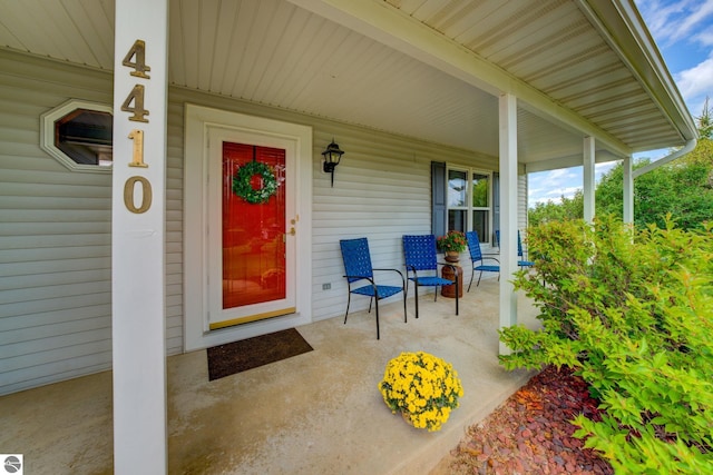 view of exterior entry featuring a porch