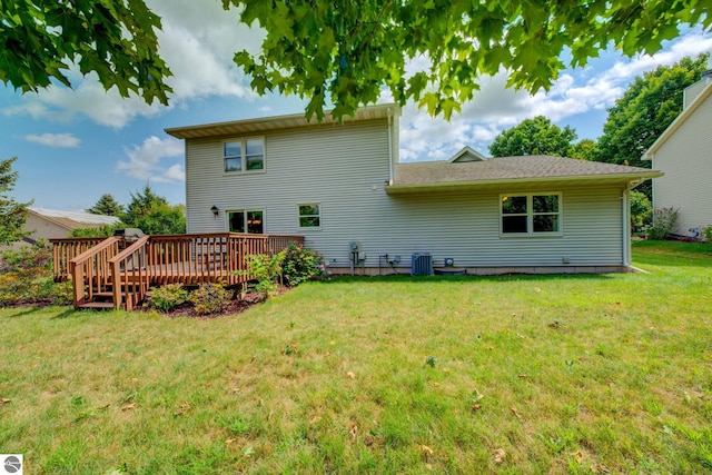 rear view of property with a lawn and a deck