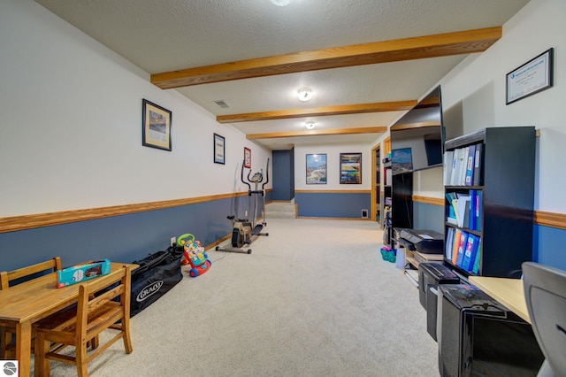 game room with carpet, beamed ceiling, and a textured ceiling