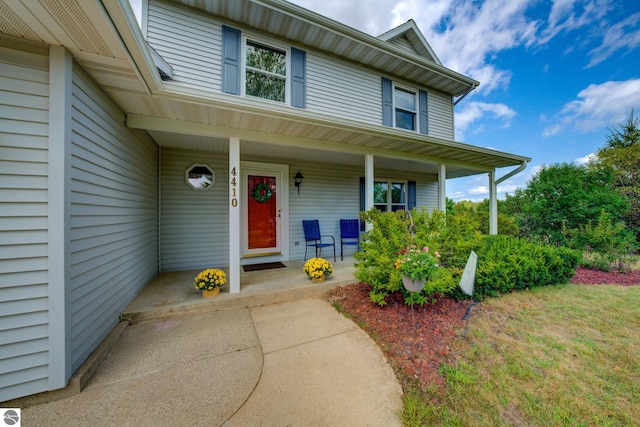 view of exterior entry featuring covered porch