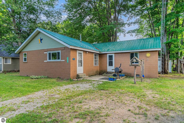 back of property featuring a lawn