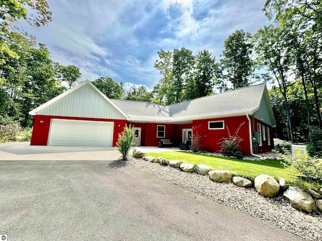 ranch-style house with a garage and a front yard