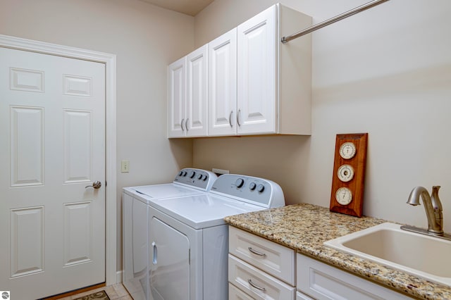 clothes washing area with sink, light tile patterned flooring, cabinets, and independent washer and dryer