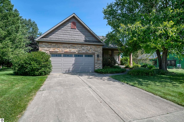 view of front of property with a front yard and a garage