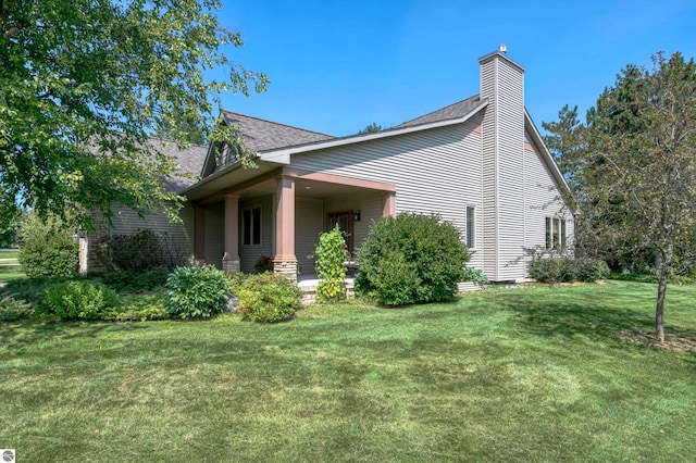 view of side of home with a lawn