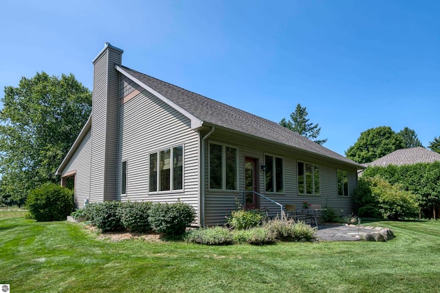 view of front of property with a patio area and a front lawn