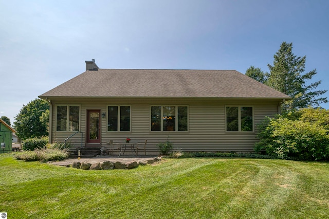 view of front of house featuring a patio area and a front lawn