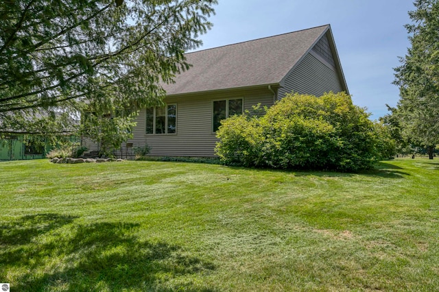 view of property exterior with a lawn