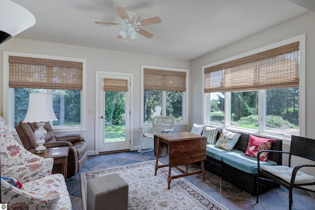 living room with ceiling fan and tile patterned floors