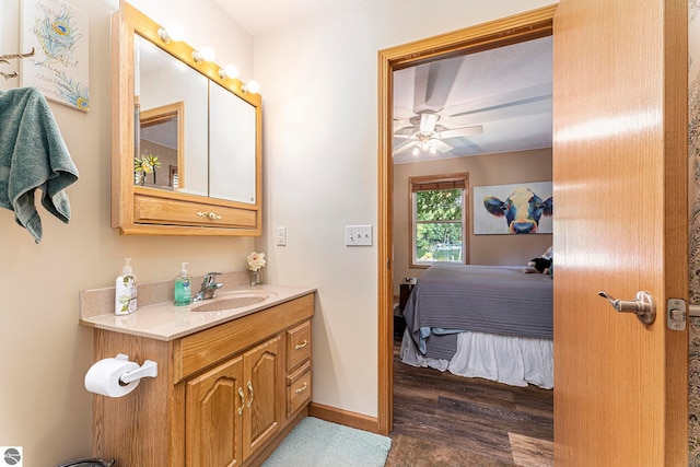 bathroom featuring ceiling fan, wood-type flooring, and vanity