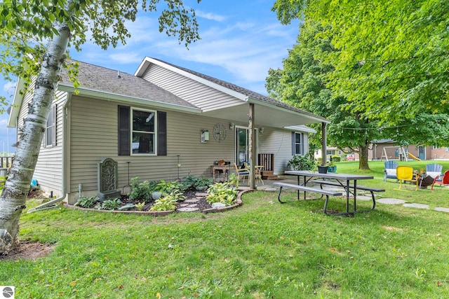 rear view of house with a yard