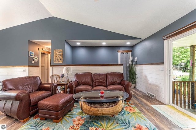 living room with vaulted ceiling and wood-type flooring