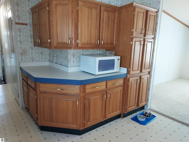 kitchen featuring light colored carpet