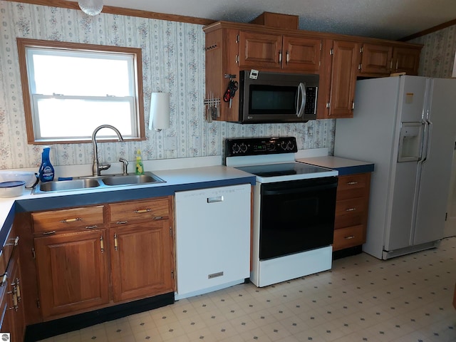 kitchen with light tile patterned floors, sink, a textured ceiling, and white appliances