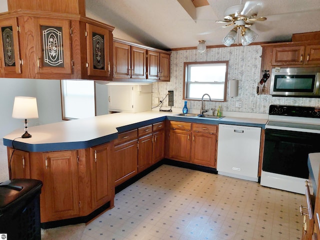 kitchen with sink, kitchen peninsula, white appliances, and light tile patterned floors