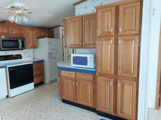 kitchen featuring backsplash, white appliances, ceiling fan, light tile patterned floors, and crown molding