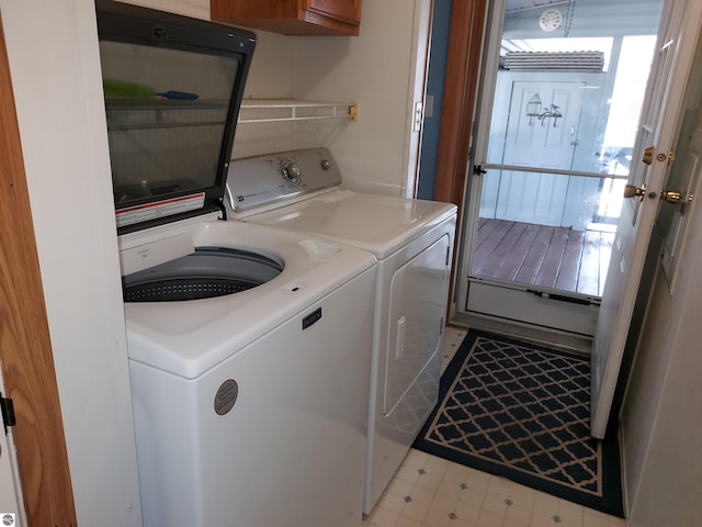 laundry room featuring washer and dryer and light tile patterned flooring