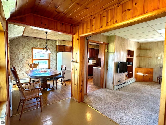 dining room featuring lofted ceiling, wood walls, wood ceiling, and a baseboard heating unit