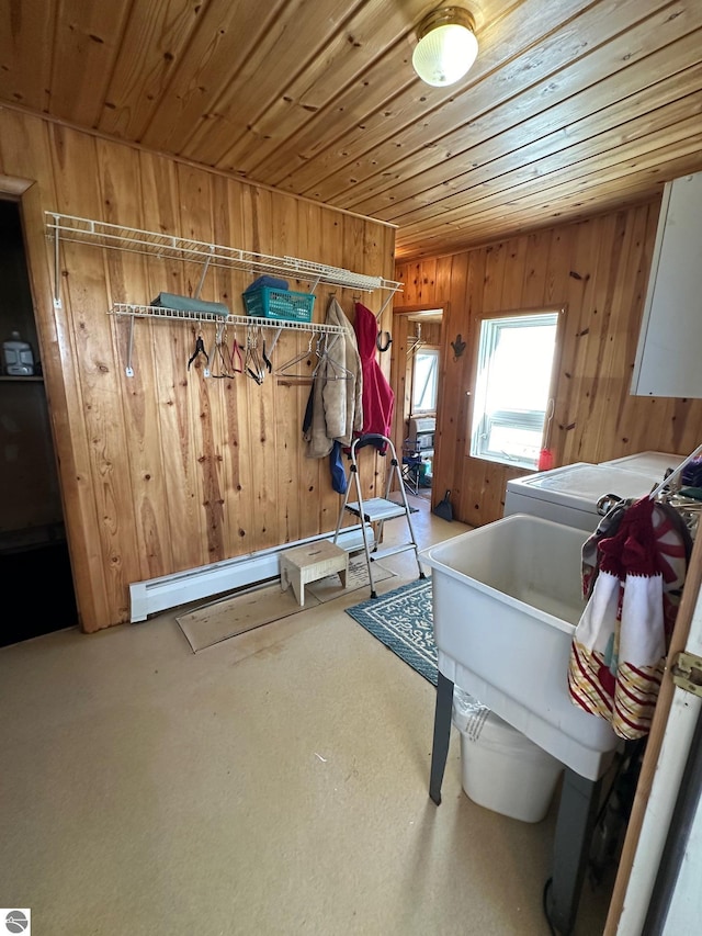 mudroom with a baseboard heating unit, washer / clothes dryer, wooden ceiling, and wood walls