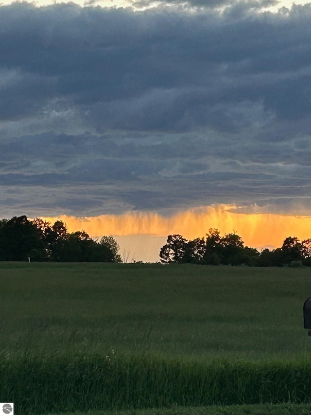 nature at dusk featuring a rural view