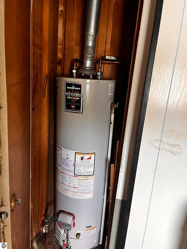 utility room featuring water heater