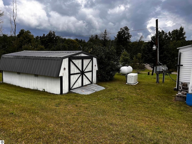 view of outbuilding featuring a yard