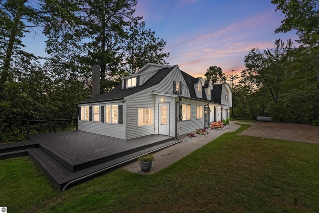 7504 W Dakota Trl, Lake City, MI 49663 - back of house with a yard, a deck, and a chimney