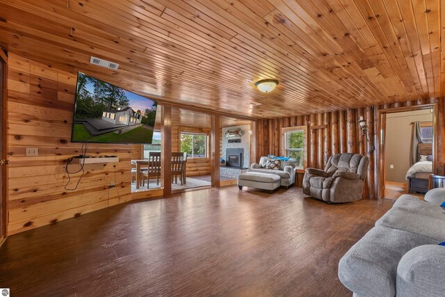 living room with wood walls, hardwood / wood-style floors, and wooden ceiling