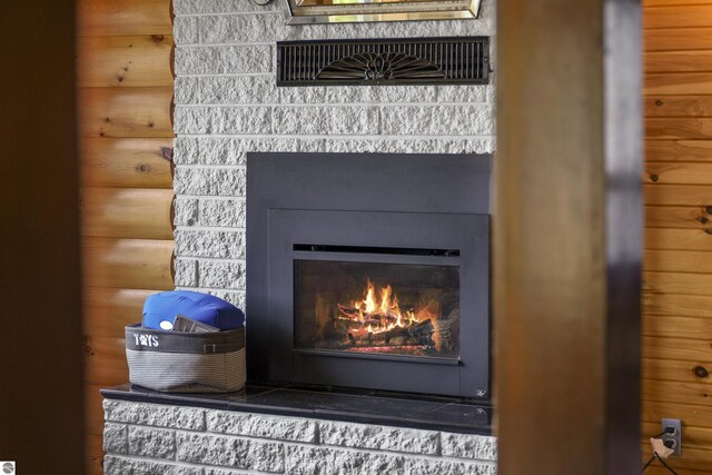 7504 W Dakota Trl, Lake City, MI 49663 - interior details featuring a glass covered fireplace
