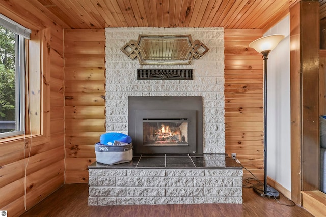 interior details with wooden ceiling, wood-type flooring, and log walls