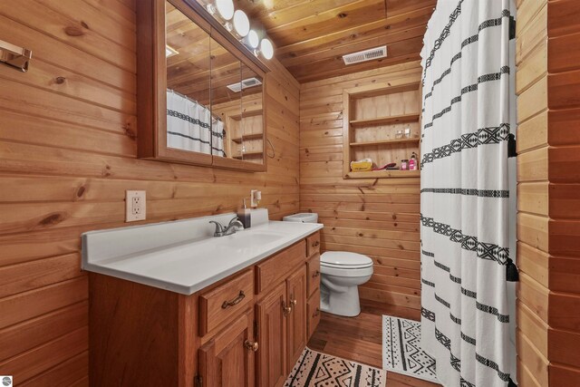 bathroom featuring vanity, wooden walls, hardwood / wood-style flooring, wooden ceiling, and toilet