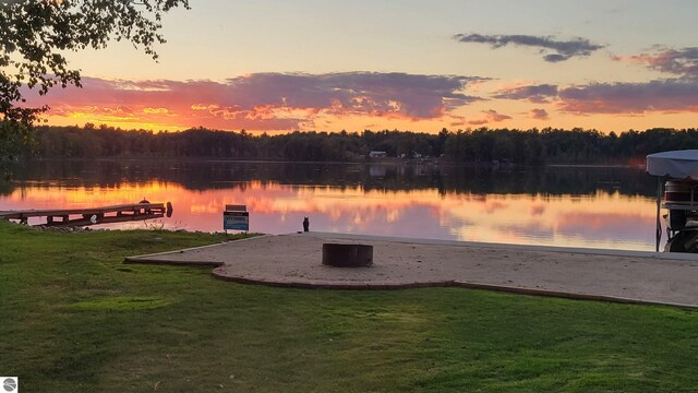7504 W Dakota Trl, Lake City, MI 49663 - view of dock featuring a lawn, a forest view, and a water view